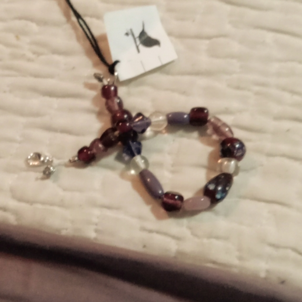 I am selling a handmaid bracelet Is one of a kind. Purple w pink glass beads s 7